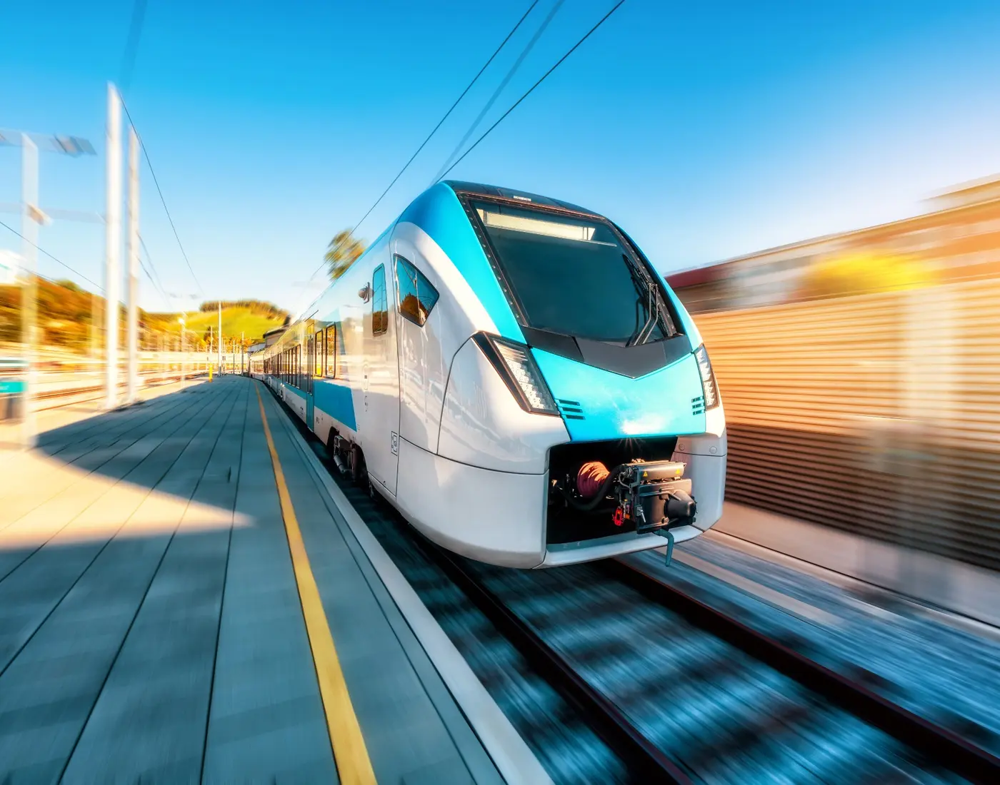 Modern passenger train travelling on an electrified railway