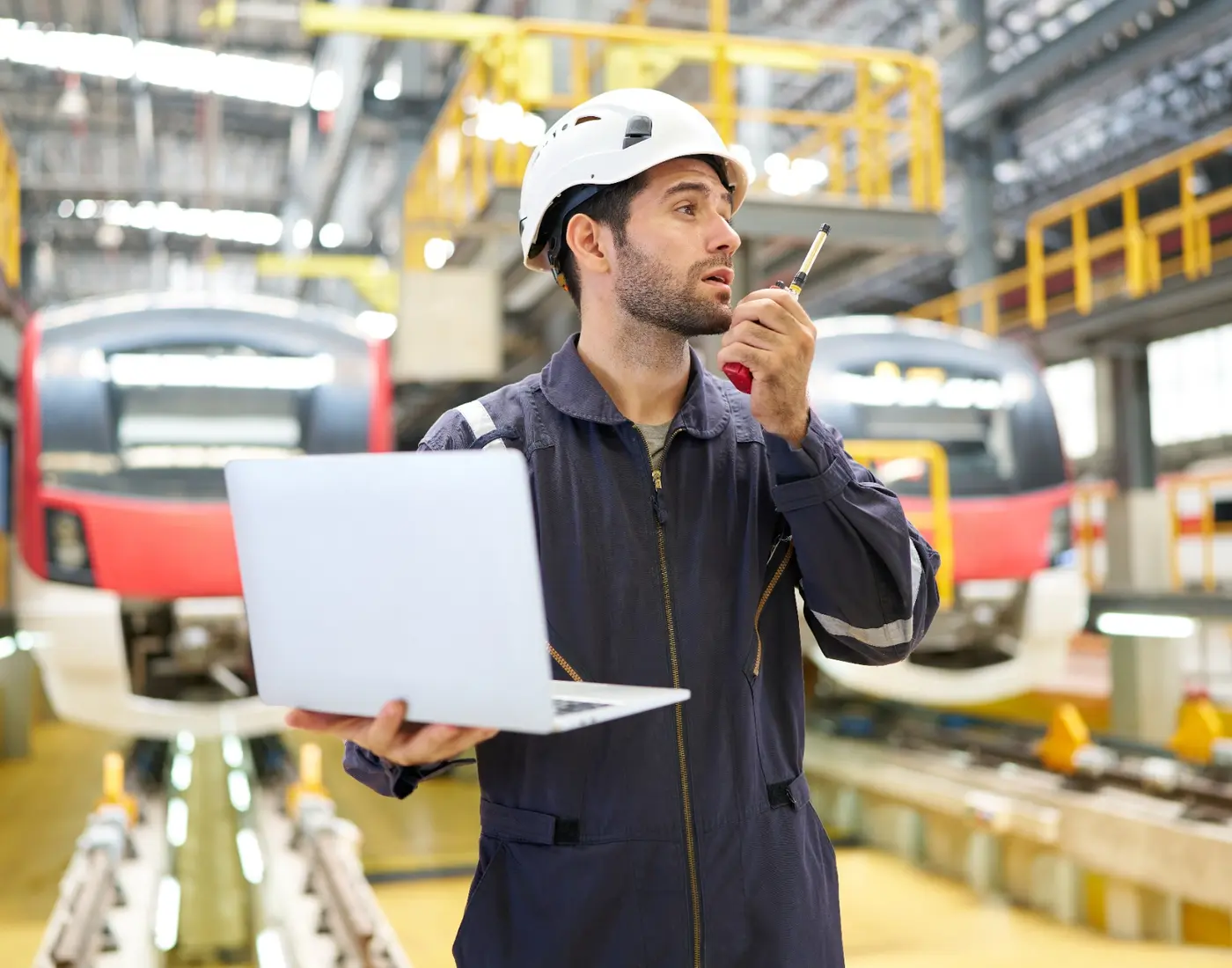 Railway engineer coordinating maintenance work in a train depot